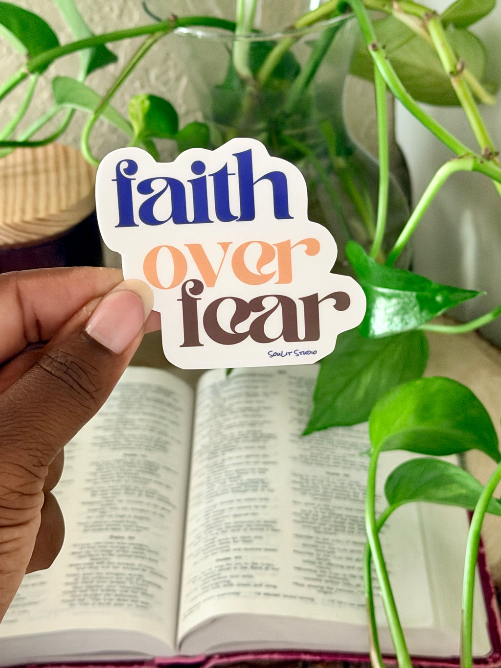 Purple, gold, and brown typography sticker reading faith over fear inspired by Psalm 56:3 for Bible study journals laptops and water bottles